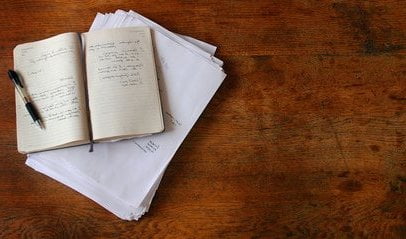 Manuscript on table plus a notebook for writing