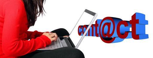 Woman writing email on laptop